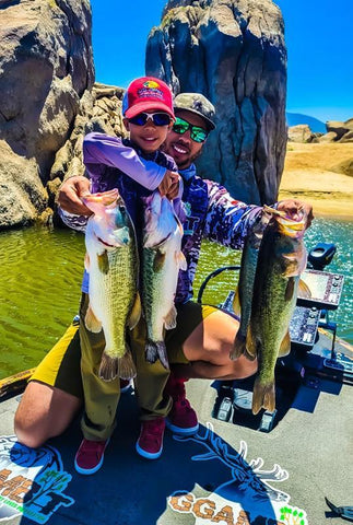 Little kid catches huge bass at Lake Isabella while wearing GGAMBIT clothing.  Jaylen Glenn and Josh Glenn load the boat at Isabella.  GGAMBIT Kids clothing apparel.  